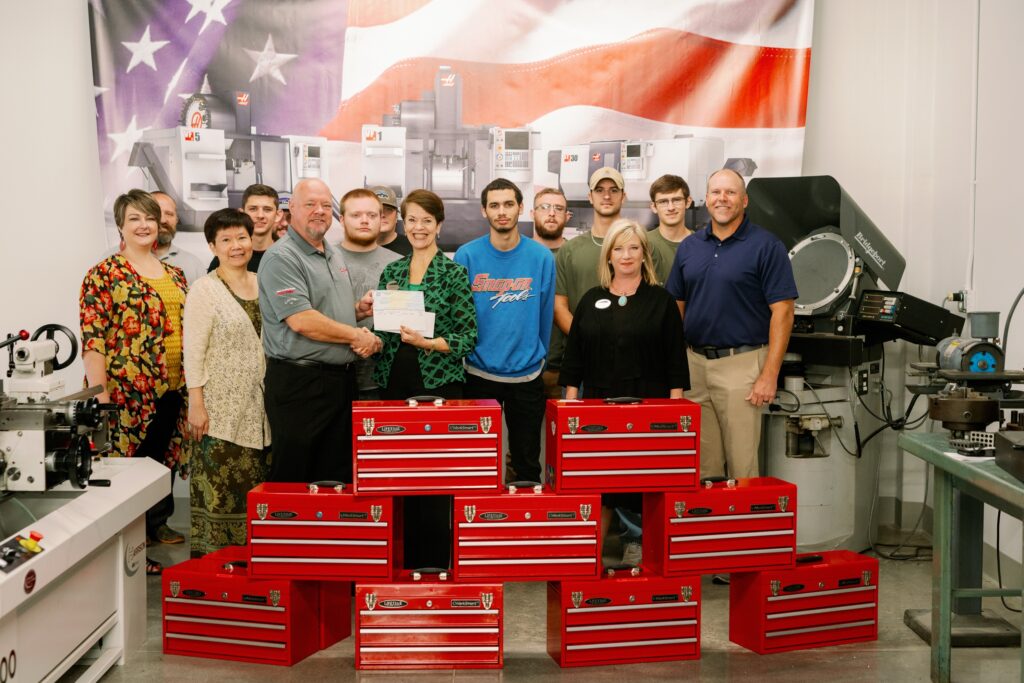 Pictured (left to right) with student toolkits purchased from funds from Haas are Leslie McFarlin, Dean of Academic Affairs; Derrick Hogan, CNC technology instructor; Christine Ta, grants coordinator; Garrett Morgan, CNC student; Matthew Chumley, CNC student; Skip Birskovich, Haas Sales Engineer Phillips Corporation; Tanner Watts, CNC student; Steven Hardy, CNC student; Cynthia Brown, director of institutional advancement; Jangel Santana, CNC student; Brandon McClain, CNC student; Clayton Brooks, CNC student; Mindy Glander, vice president of academic affairs; John “Dillan” Hill, CNC student; Shannon Gary, CNC technology instructor.