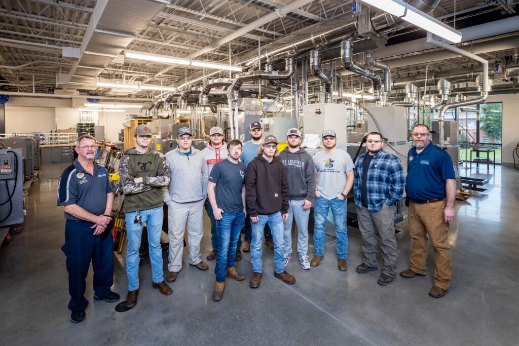 Recent students of the Air Conditioning Technology program with instructors Glenn Jordan (left) and Bryan Hartzog (right), who were pivotal in the reaccreditation process. 