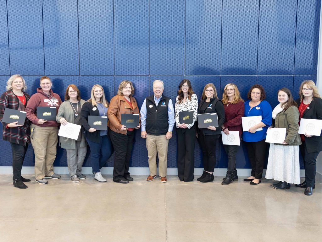 Five-year Service Awards (L to R): Jennifer Garrett; Tina Dellaposta; Sharon McFarland; Jessica Huff; Millie Caudell; NGTC President John Wilkinson; Lindsay Adams; Brandy Qualls; Leslie Ring; Vickie Sullens; Kelsey McIntire; Jerri Beasley; (not pictured) Kevin McCurry; and Jamey Wilkes